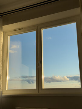 Fototapeta Window view of blue sky with soft clouds