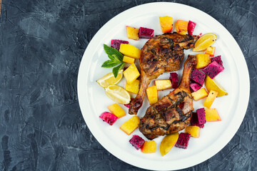 Duck roast with baked exotic fruits.