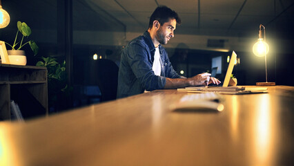 Desk, laptop and night with business man in office for deadline or feedback on creative report....
