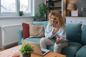 Young woman talking on video call with her psychotherapist doctor after online therapy sessions,...