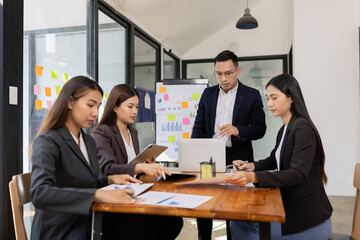 Group of business people working together with dashboard analysis and data management a meeting...