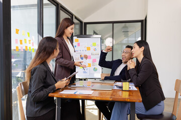Group of Asian business working plan analysis project brainstorm in modern office, Asian...