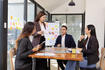 Group of Asian business working plan analysis project brainstorm in modern office, Asian businesspeople team working together, Business startup and company strategy planning concept.
