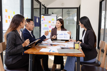 Group of Asian business working plan analysis project brainstorm in modern office, Asian businesspeople team working together, Business startup and company strategy planning concept.
