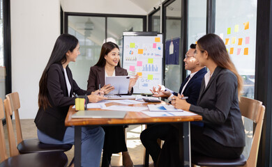 Group of Asian business working plan analysis project brainstorm in modern office, Asian businesspeople team working together, Business startup and company strategy planning concept.
