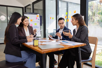 Group of Asian business working plan analysis project brainstorm in modern office, Asian businesspeople team working together, Business startup and company strategy planning concept.
