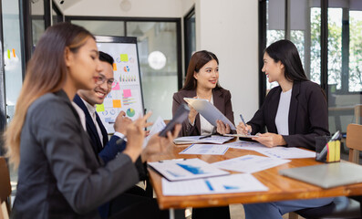 Group of Asian business working plan analysis project brainstorm in modern office, Asian...