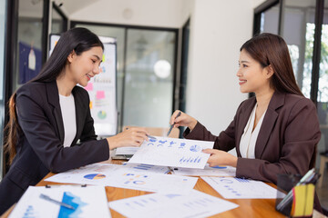 Businesswomen working plan analysis project brainstorm in modern office, Asian businesspeople team working together, Business startup and company strategy planning concept.