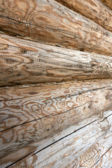 Wall of wooden logs with distinct patterns and textures, background photo
