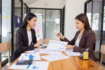 Businesswomen working plan analysis project brainstorm in modern office, Asian businesspeople team working together, Business startup and company strategy planning concept.
