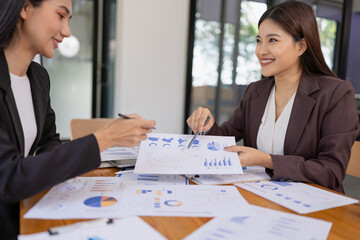 Businesswomen working plan analysis project brainstorm in modern office, Asian businesspeople team working together, Business startup and company strategy planning concept.