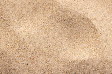 Detailed view of textured golden quartz sand under natural lighting