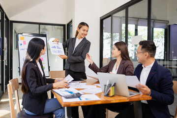 Obraz premium Group of Asian business working with analysis project brainstorm in modern office, Asian businesspeople team working together, Business startup and company strategy planning concept.