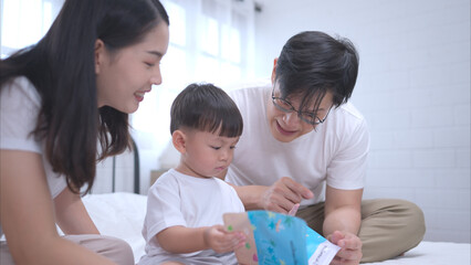 Before putting the kids to bed, parents, and kid unwind and play in the bedroom