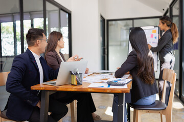 Group of Asian business working with analysis project brainstorm in modern office, Asian businesspeople team working together, Business startup and company strategy planning concept.