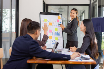 Group of Asian business working with analysis project brainstorm in modern office, Asian businesspeople team working together, Business startup and company strategy planning concept.