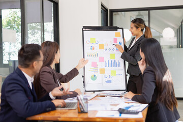 Group of Asian business working with analysis project brainstorm in modern office, Asian businesspeople team working together, Business startup and company strategy planning concept.