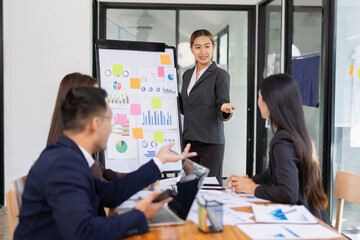 Group of Asian business working with analysis project brainstorm in modern office, Asian businesspeople team working together, Business startup and company strategy planning concept.