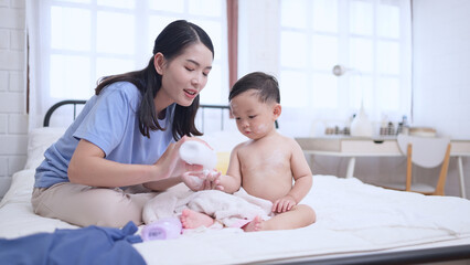 Happy time after bath, Asian kid and mother enjoying are having fun
