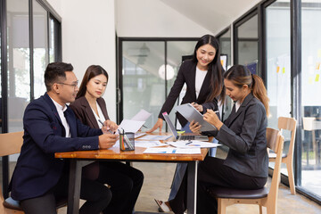 Group of Asian business working with analysis project brainstorm in modern office, Asian businesspeople team working together, Business startup and company strategy planning concept.