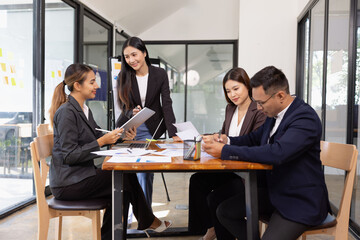 Fototapeta premium Group of Asian business working with analysis project brainstorm in modern office, Asian businesspeople team working together, Business startup and company strategy planning concept.