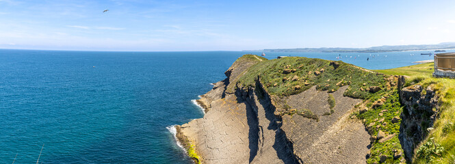 Landscape from the Santander Lighthouse. Steep rocks falling into the sea and the intensely blue...
