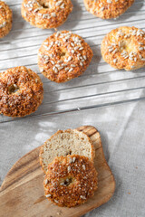 Healthy homemade oat bagels on rustic sunny background. Place for text.