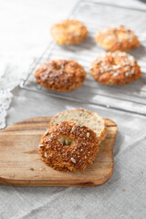 Healthy homemade oat bagels on rustic sunny background. Place for text.