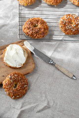 Healthy homemade oat bagels on rustic sunny background. Place for text.