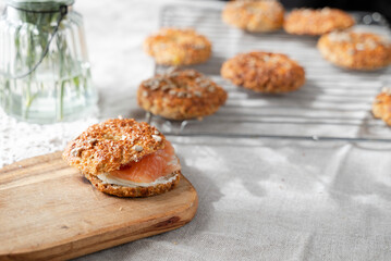 Healthy homemade oat bagels on rustic sunny background. Place for text.