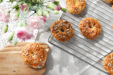 Healthy homemade oat bagels on rustic sunny background. Place for text.