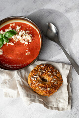 Gazpacho, cold tomato soup on grey table. Minimalistic, place for text