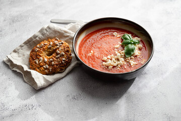 Gazpacho, cold tomato soup on grey table. Minimalistic, place for text