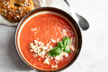 Gazpacho, cold tomato soup on grey table. Minimalistic, place for text. Close-up