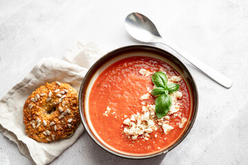 Gazpacho, cold tomato soup on grey table. Minimalistic, place for text
