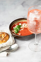 Gazpacho, cold tomato soup on grey table. Minimalistic, place for text