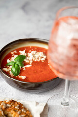Gazpacho, cold tomato soup on grey table. Minimalistic, place for text