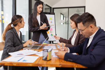 Group of Asian business working with analysis project brainstorm in modern office, Asian businesspeople team working together, Business startup and company strategy planning concept.