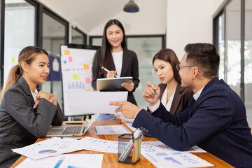 Group of Asian business working with analysis project brainstorm in modern office, Asian businesspeople team working together, Business startup and company strategy planning concept.