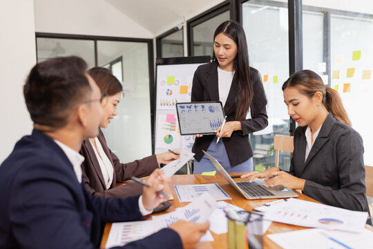 Group of Asian business working with analysis project brainstorm in modern office, Asian businesspeople team working together, Business startup and company strategy planning concept.