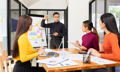 Group of Asian business working analysis project brainstorm in modern office, Asian businesspeople team working together, Business startup and company strategy planning concept.