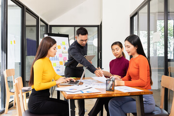 Group of Asian business working analysis project brainstorm in modern office, Asian businesspeople team working together, Business startup and company strategy planning concept.