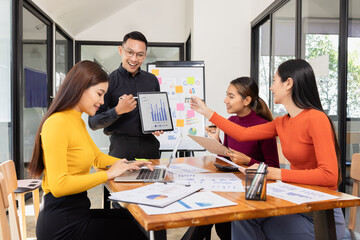 Group of Asian business working analysis project brainstorm in modern office, Asian businesspeople team working together, Business startup and company strategy planning concept.