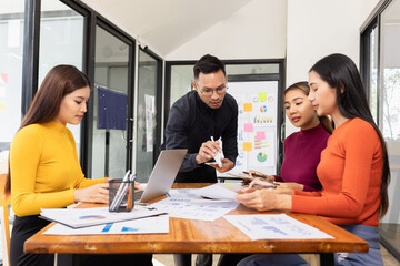 Group of Asian business working analysis project brainstorm in modern office, Asian businesspeople team working together, Business startup and company strategy planning concept.