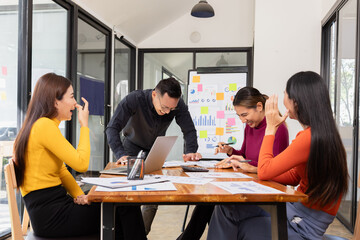 Group of happy asian businesspeople celebrate project brainstorm at modern office.