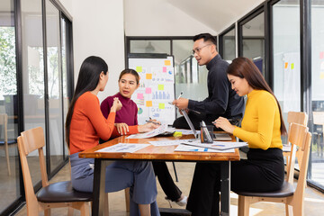 Group of Asian business working analysis project brainstorm in modern office, Asian businesspeople team working together, Business startup and company strategy planning concept.