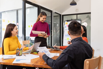 Group of Asian business working analysis project brainstorm in modern office, Asian businesspeople team working together, Business startup and company strategy planning concept.