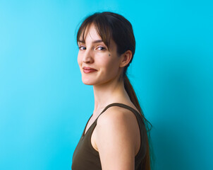 Portrait of girl against a vibrant blue backdrop