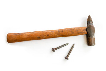 Hammer and metal nails isolated on white background