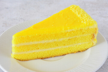 A Delicious Slice of Lemon Cake on a White Plate close up